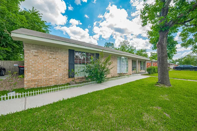 a front view of house with a garden