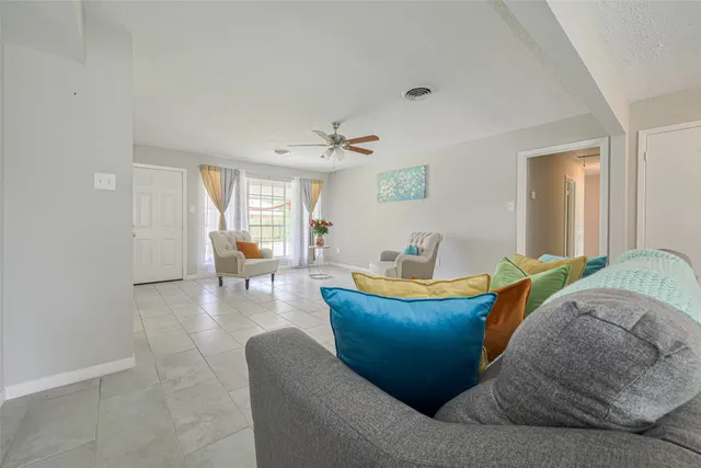 a living room with furniture and a large window
