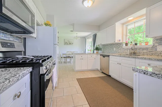 a kitchen with a stove top oven sink and cabinets