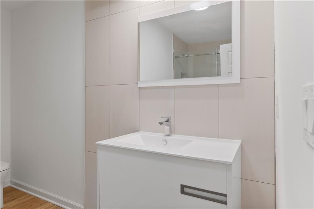 8965 Laurel Way Alpharetta, GA 30022 - Photo 38 of 79 a bathroom with a sink and a mirror