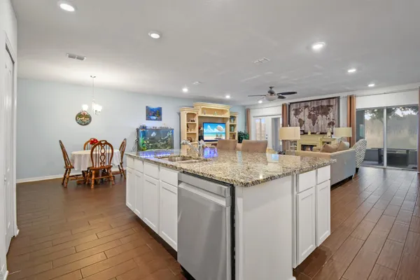 a kitchen with stainless steel appliances granite countertop a sink and a stove