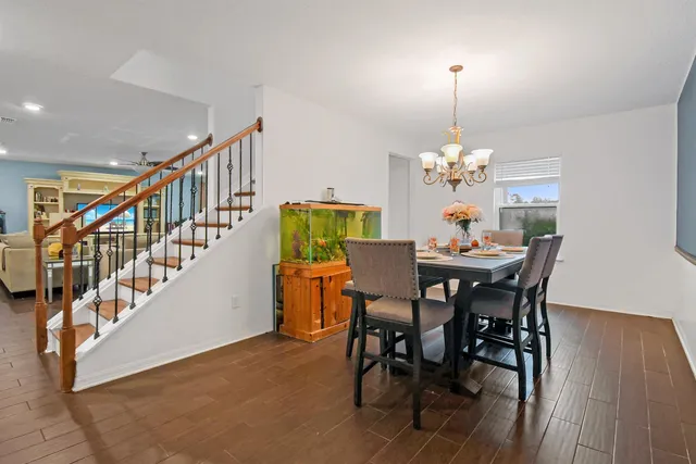 a view of a dining room with furniture and chandelier