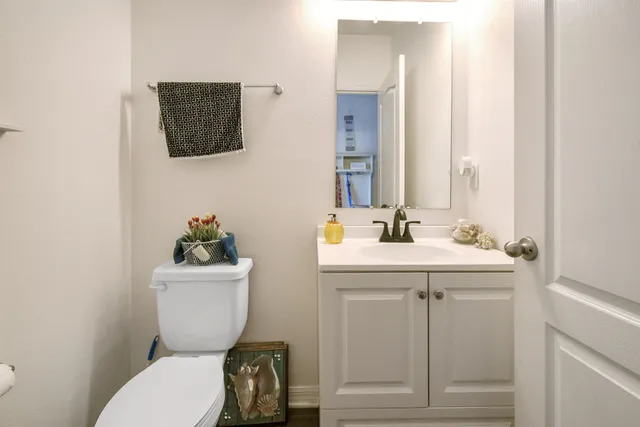 a bathroom with a toilet sink and mirror