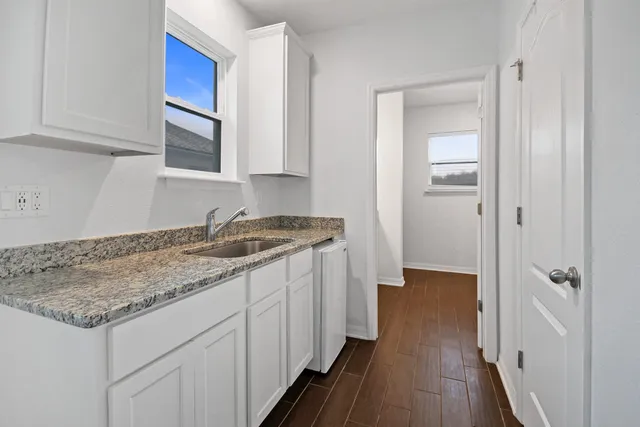 a kitchen with a sink stove and cabinets