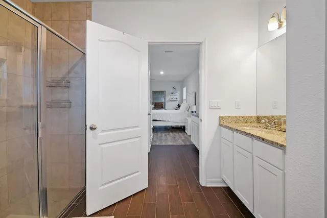 a view of a kitchen from the hallway with a wooden floor