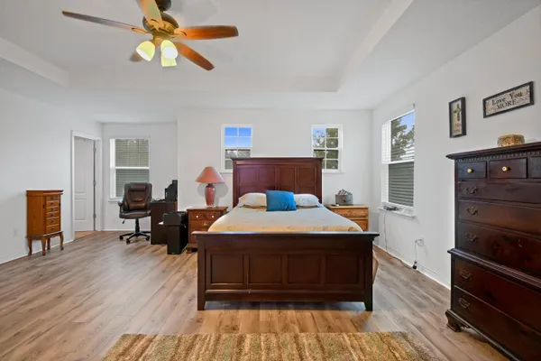 a bedroom with a bed and wooden floor