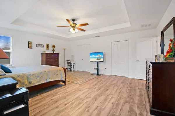 a bedroom with a bed and a chandelier