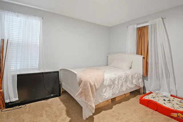 a bedroom with a bed and a window