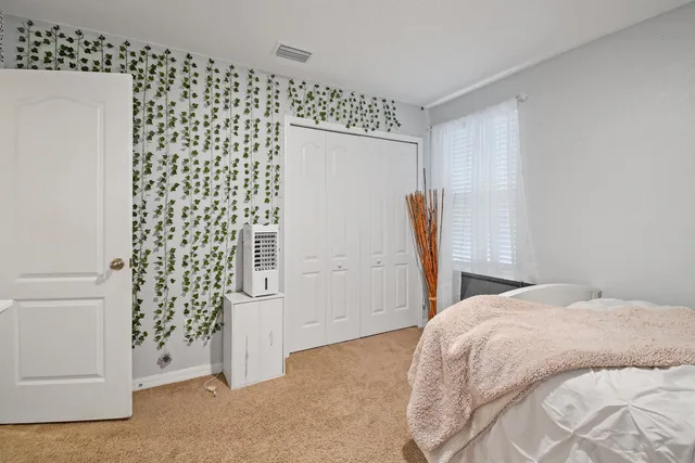 a bedroom with a bed and a window