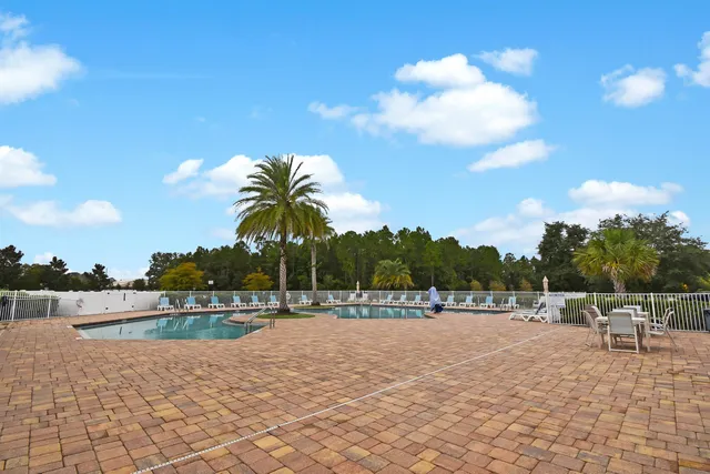 a view of swimming pool and lake in the back