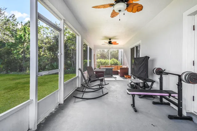 a living room with furniture and a floor to ceiling window