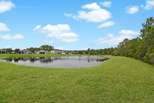 a view of a lake with houses in the back