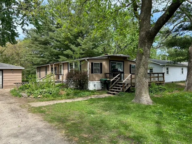 a view of a house with backyard sitting area and garden