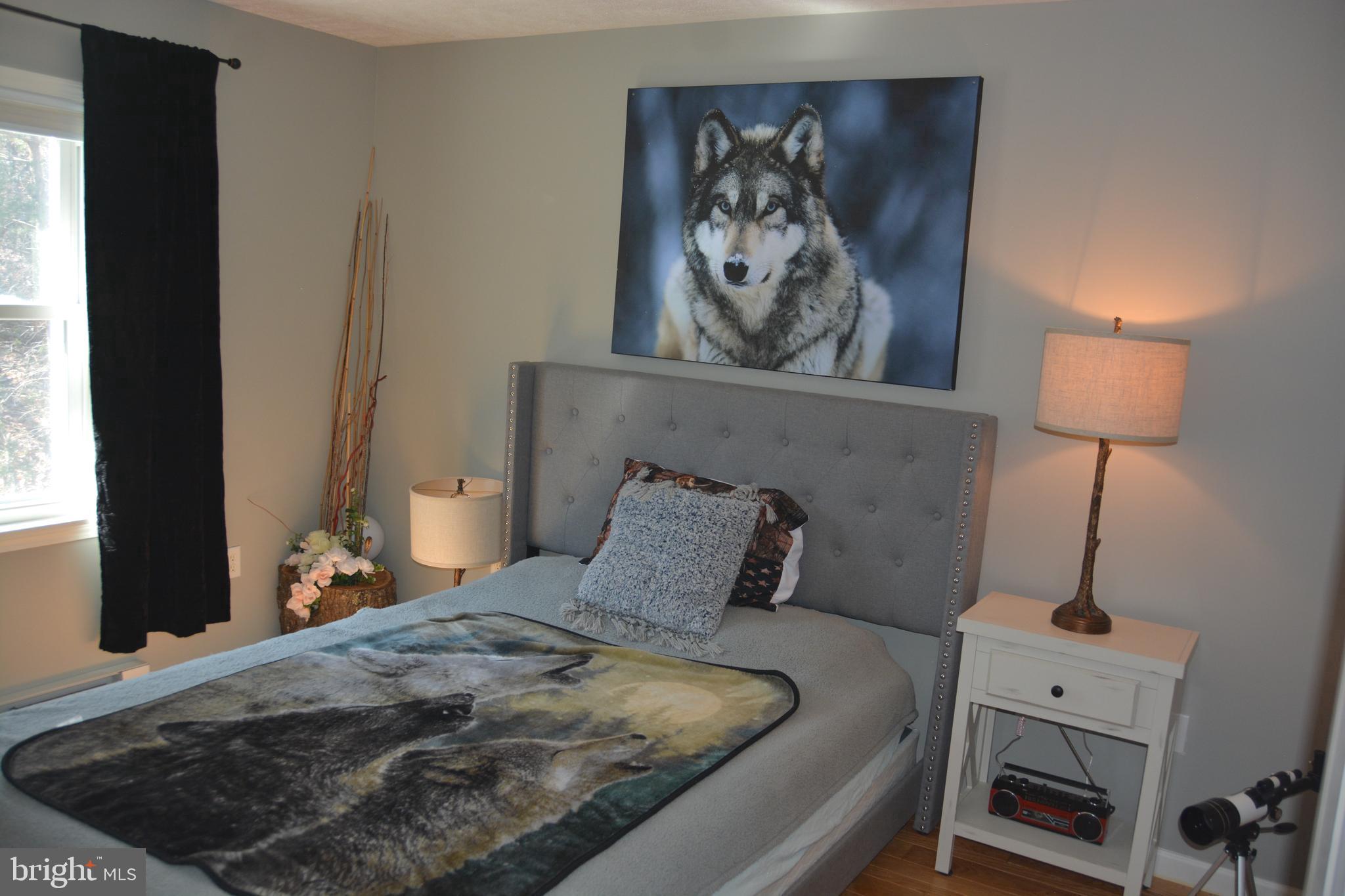 400 Locust Ridge Moorefield, WV 26836 - Photo 36 of 87 a bedroom with a bed and a painting on the wall