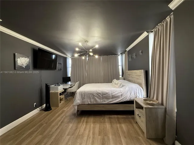 a bed room with a bed and a television