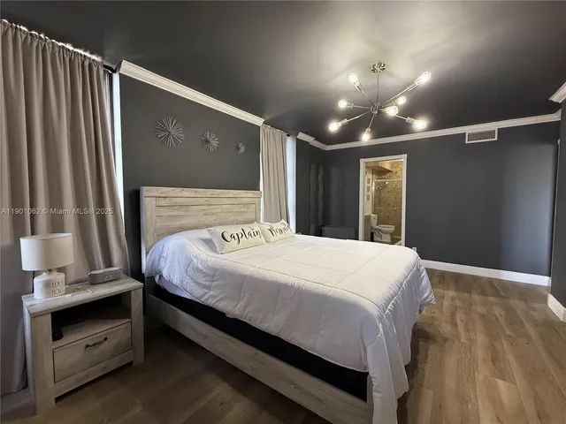 a bedroom with a bed and a mirror