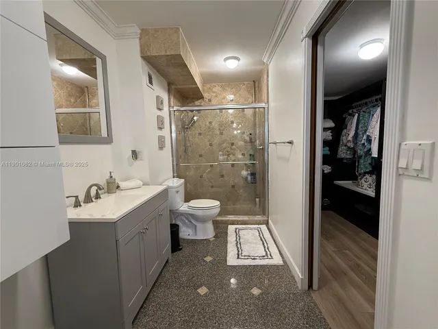 a bathroom with a sink toilet and shower