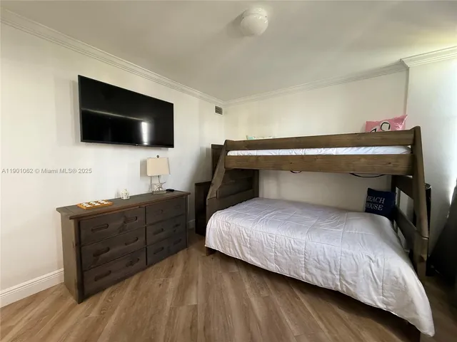 a bedroom with a bed and a flat screen television