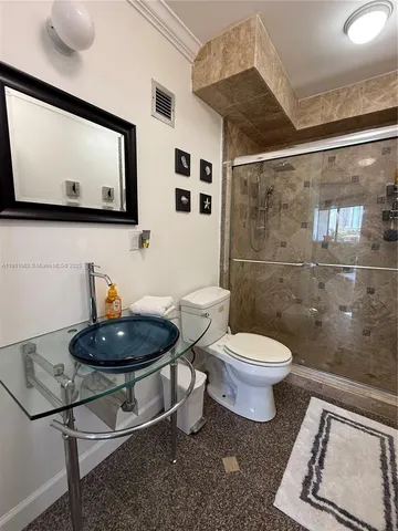 a bathroom with a toilet a sink and mirror