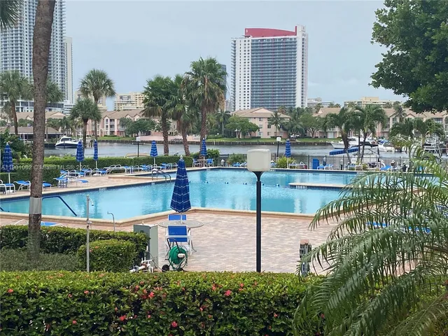 a view of swimming pool with outdoor seating and yard in the back