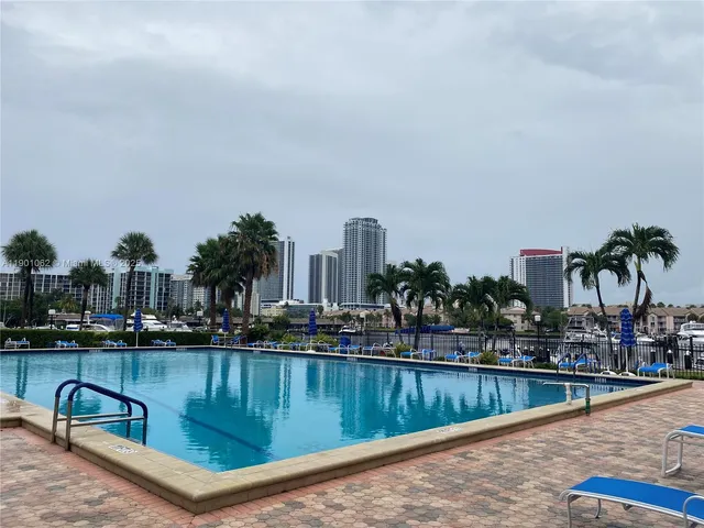 a room with gym equipment and large windows