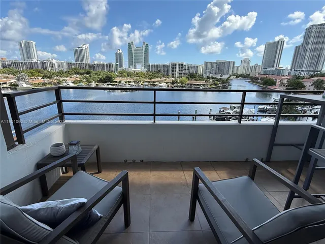 a view of a chairs and table in a balcony