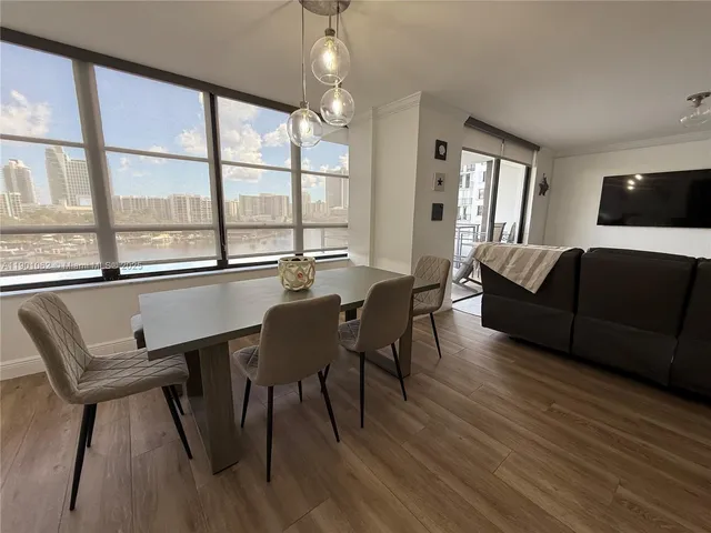 a view of a dining room with furniture window and wooden floor