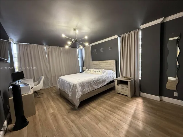 a bedroom with a bed and a mirror