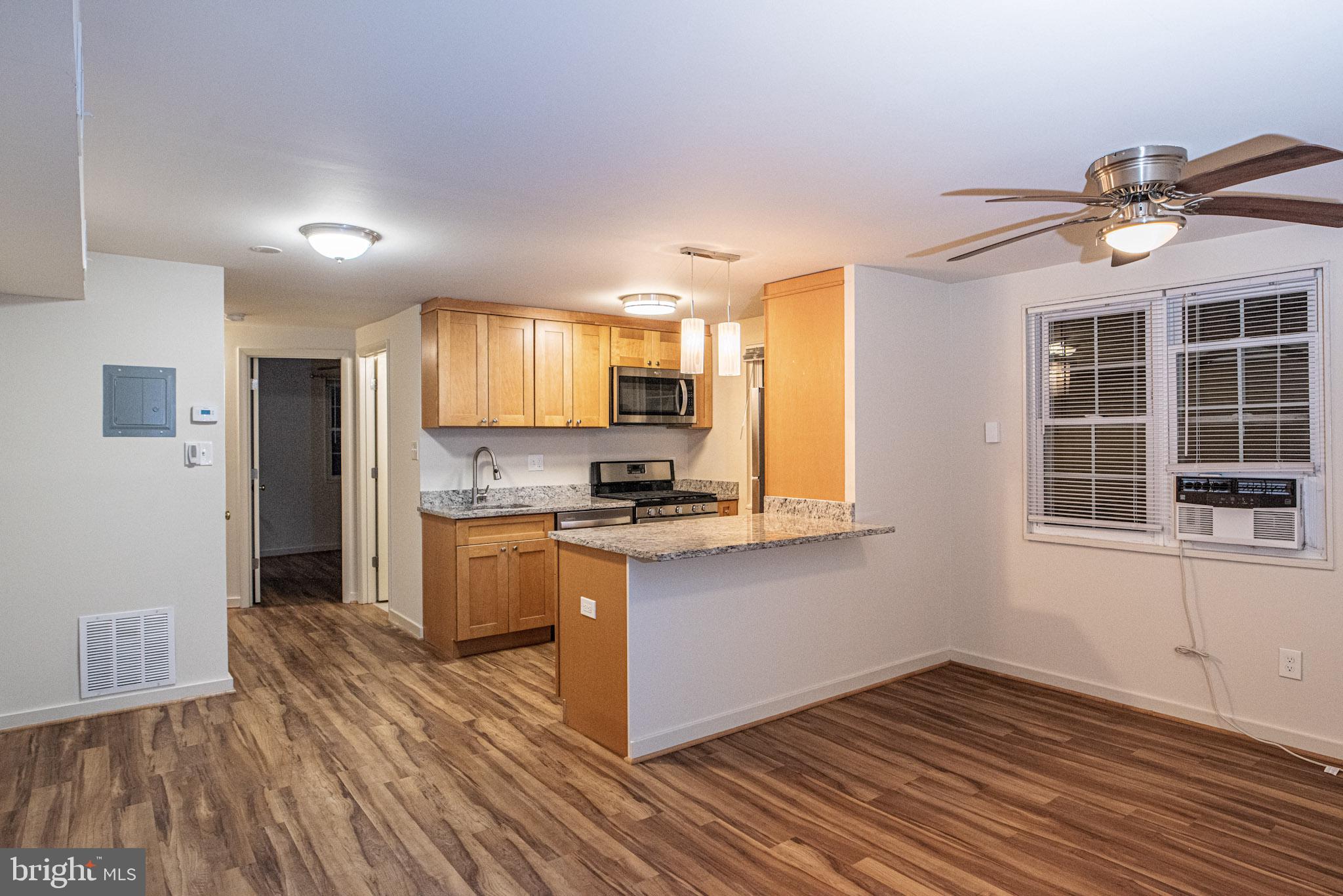 129 South Courthouse Road, Unit 9 Arlington, VA 22204 - Photo 2 of 12 a kitchen with granite countertop a stove a sink and a refrigerator