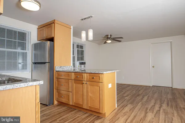 a view of a kitchen with cabinets and wooden floor