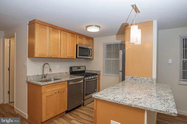 a kitchen with a sink stove and microwave
