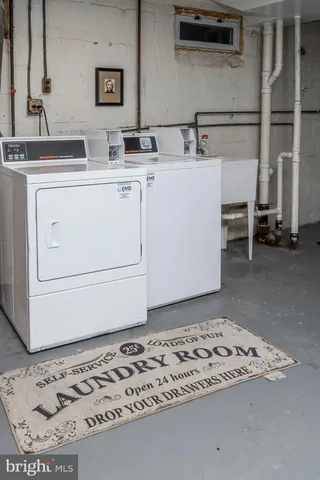 a view of a storage & utility room with a washer dryer