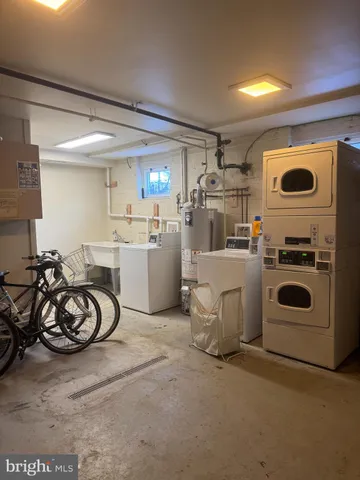 a view of a storage and utility room with dryer and washer