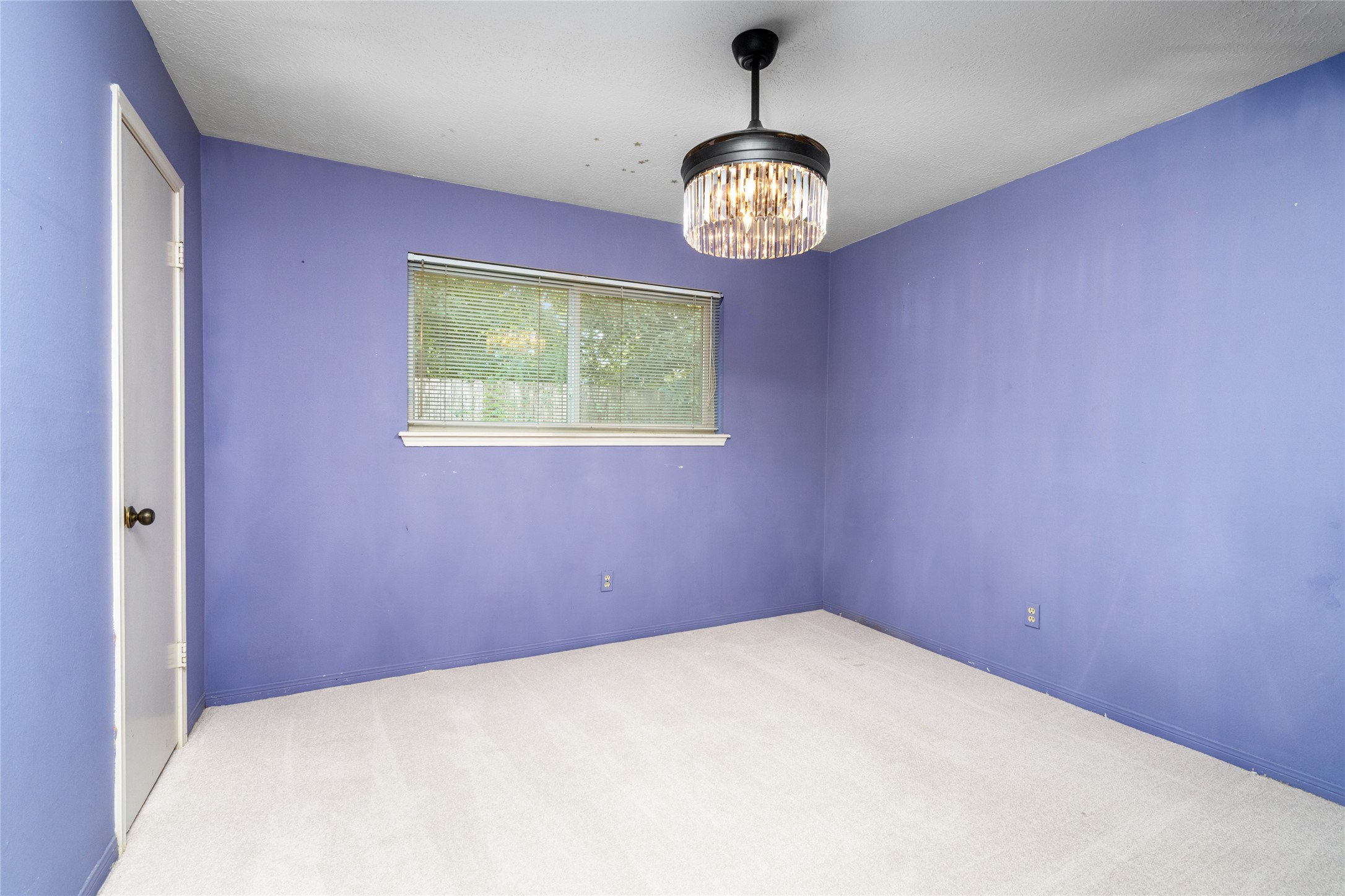 7015 Rosebrook Circle Spring, TX 77379 - Photo 10 of 15 Bright third bedroom suite showcases an updated window, soft carpet, and a stylish light fixture.