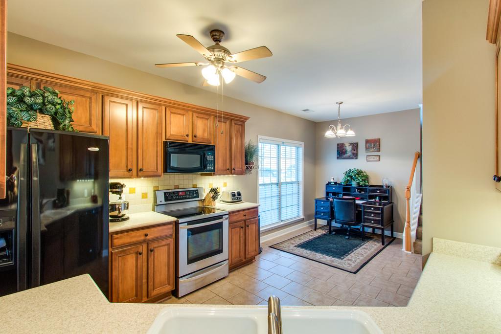 403 Reagan Road Mount Juliet, TN 37122 - Photo 11 of 30 a living room with furniture a flat screen tv and kitchen view