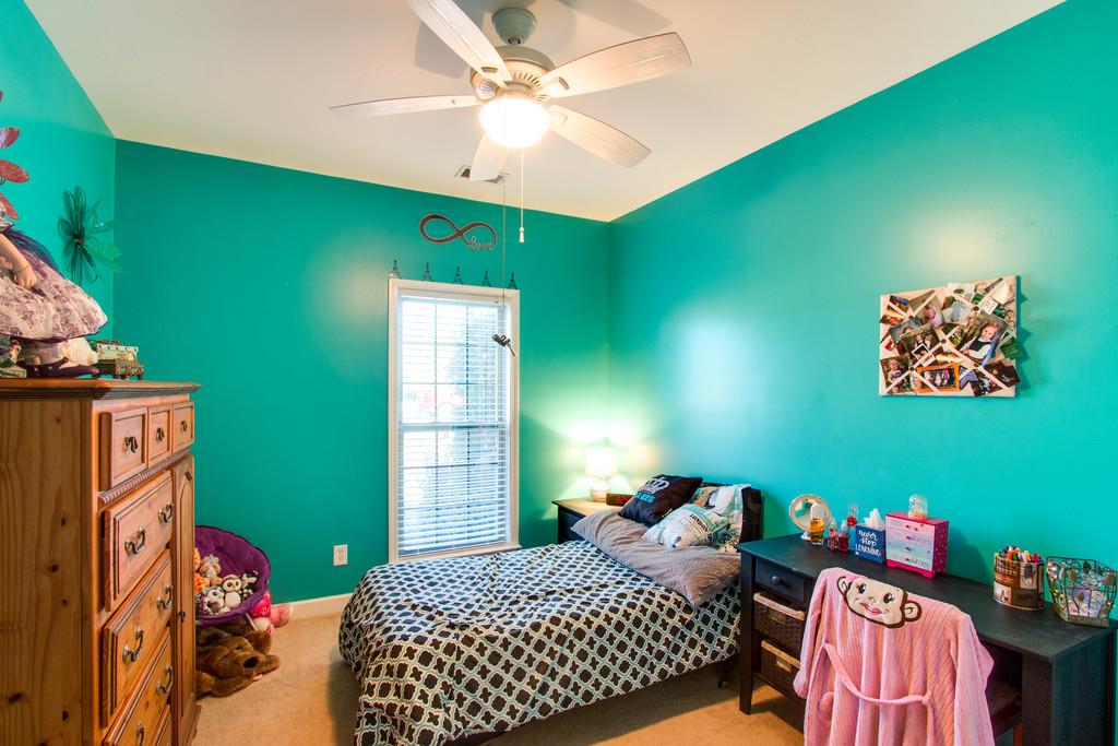 403 Reagan Road Mount Juliet, TN 37122 - Photo 21 of 30 a bedroom with a bed and a chandelier