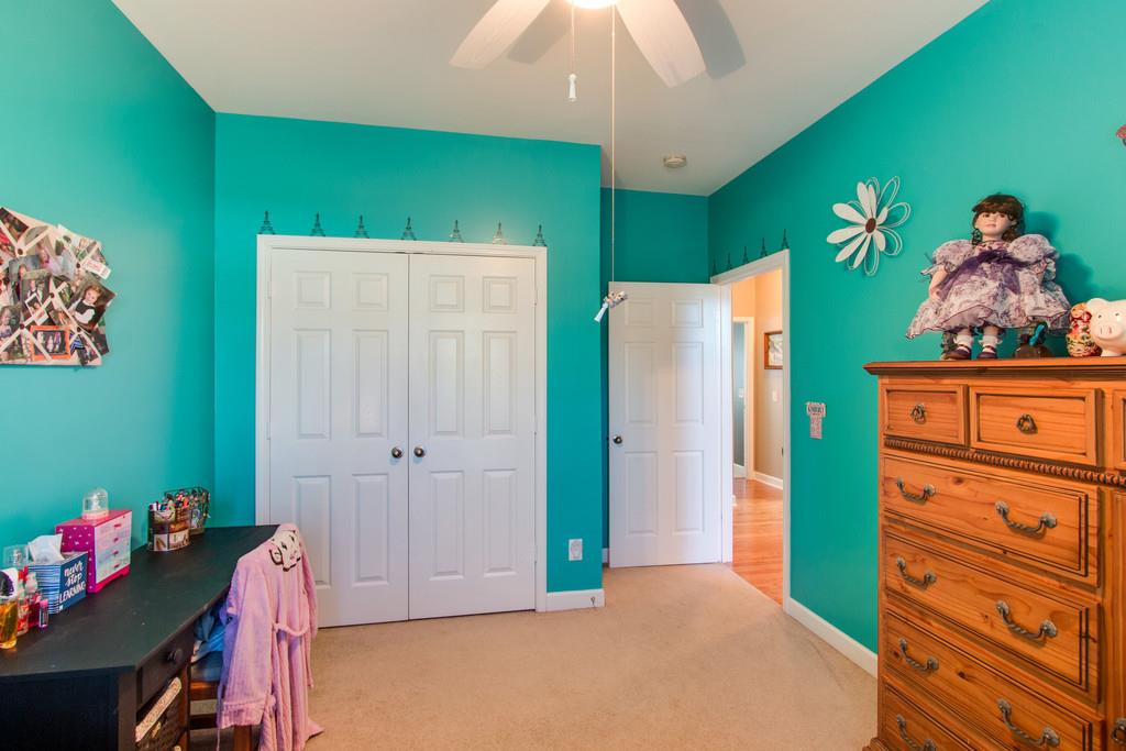 403 Reagan Road Mount Juliet, TN 37122 - Photo 22 of 30 a bedroom with a bed and a chandelier