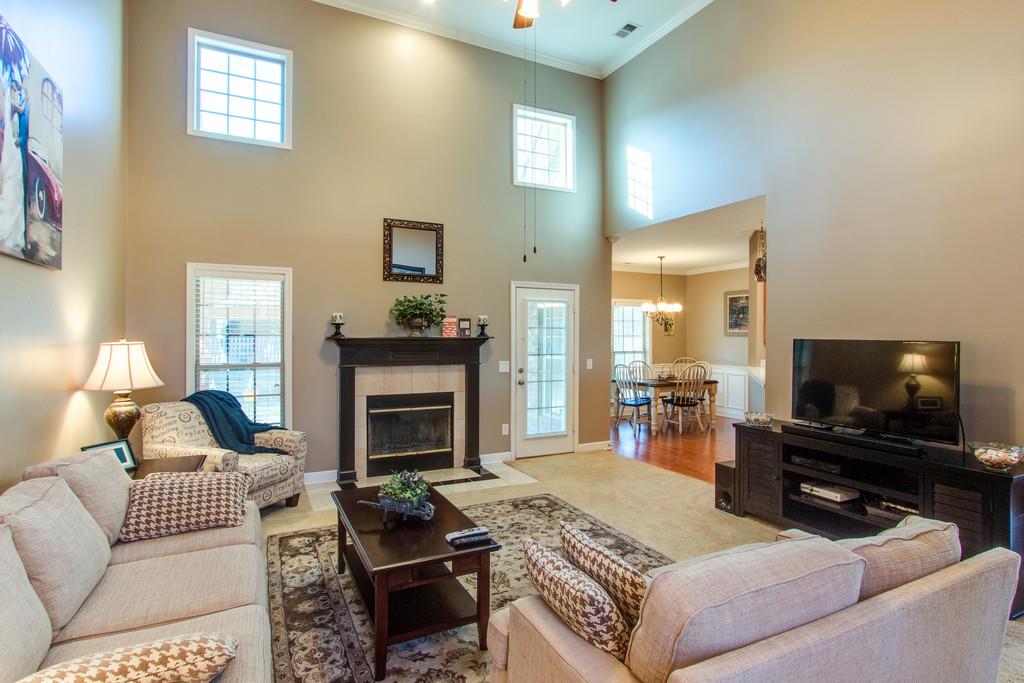 403 Reagan Road Mount Juliet, TN 37122 - Photo 4 of 30 a living room with furniture a flat screen tv and a fireplace