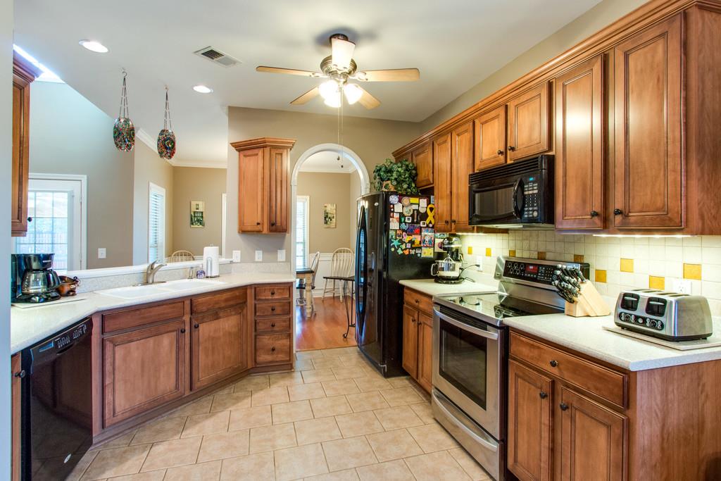 403 Reagan Road Mount Juliet, TN 37122 - Photo 9 of 30 a kitchen with stainless steel appliances granite countertop a stove top oven a sink dishwasher a refrigerator and a refrigerator with wooden floor