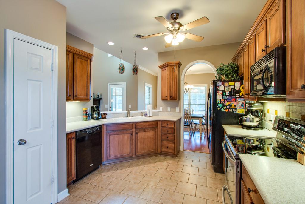 403 Reagan Road Mount Juliet, TN 37122 - Photo 10 of 30 a large kitchen with stainless steel appliances granite countertop a stove top oven a sink a dining table and chairs