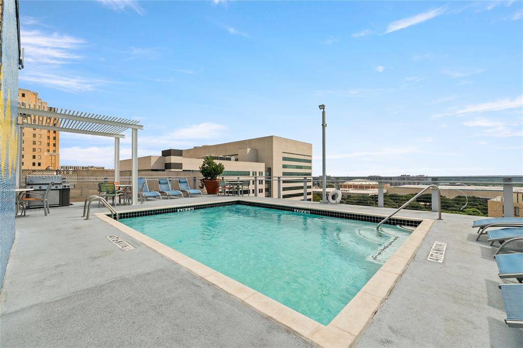 1122 Jackson Street, Unit 811 Dallas, TX 75202 - Photo 22 of 28 a view of a swimming pool outdoor seating