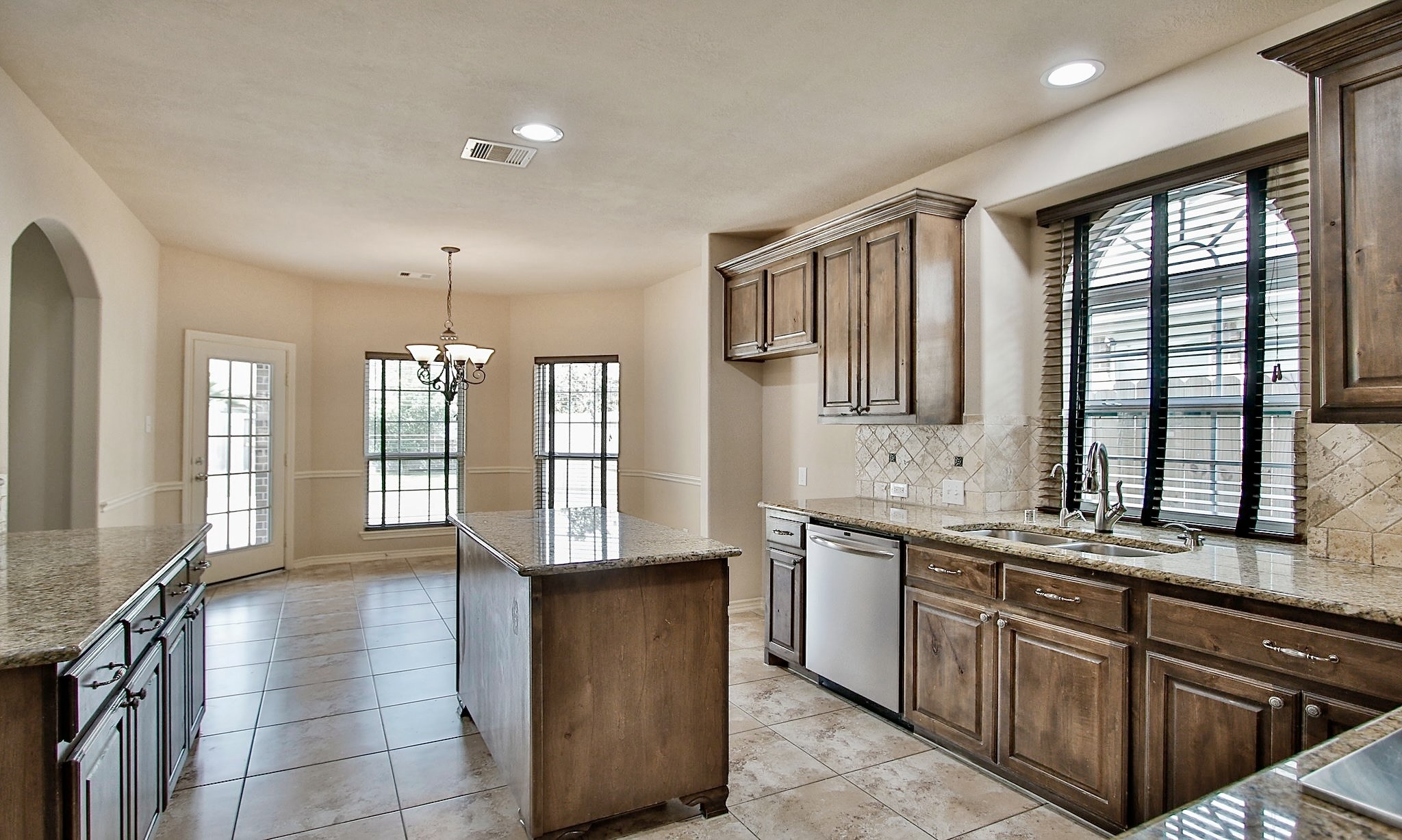 19818 Iceland Court Spring, TX 77379 - Photo 14 of 35 a large kitchen with stainless steel appliances a sink and cabinets