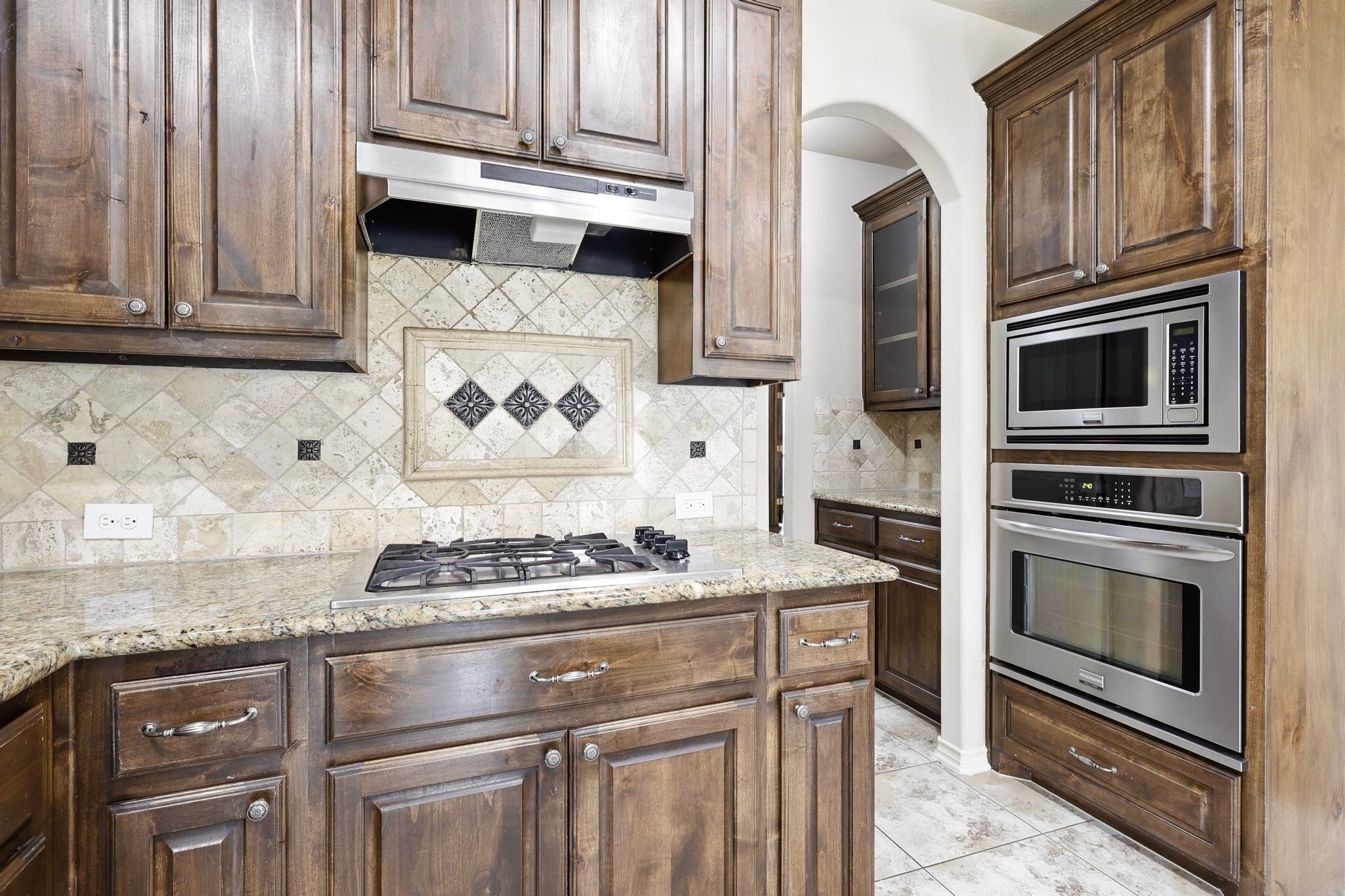 19818 Iceland Court Spring, TX 77379 - Photo 16 of 35 a kitchen with granite countertop stainless steel appliances and cabinets