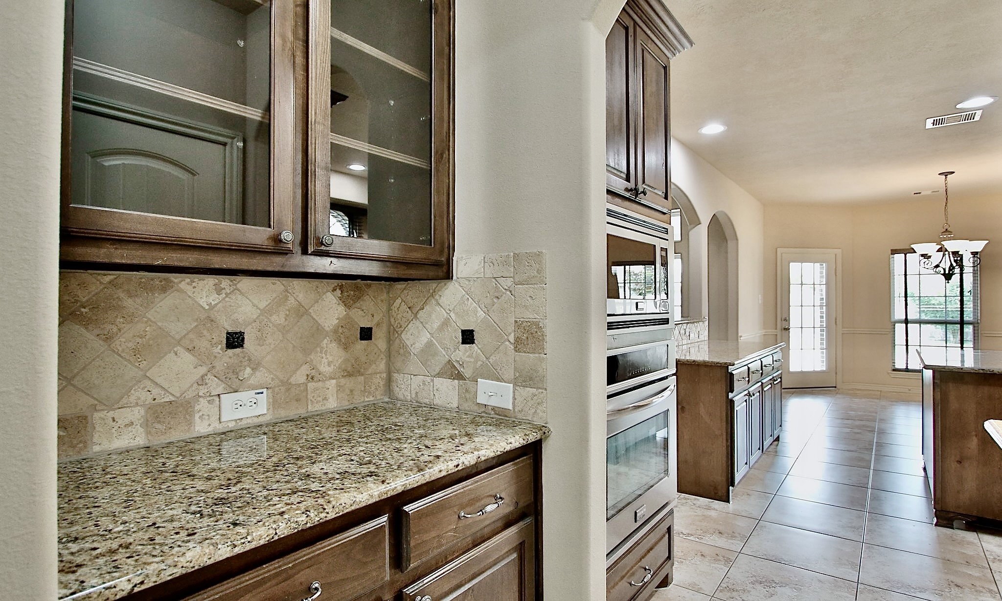 19818 Iceland Court Spring, TX 77379 - Photo 17 of 35 a kitchen with granite countertop stainless steel appliances and wooden cabinets