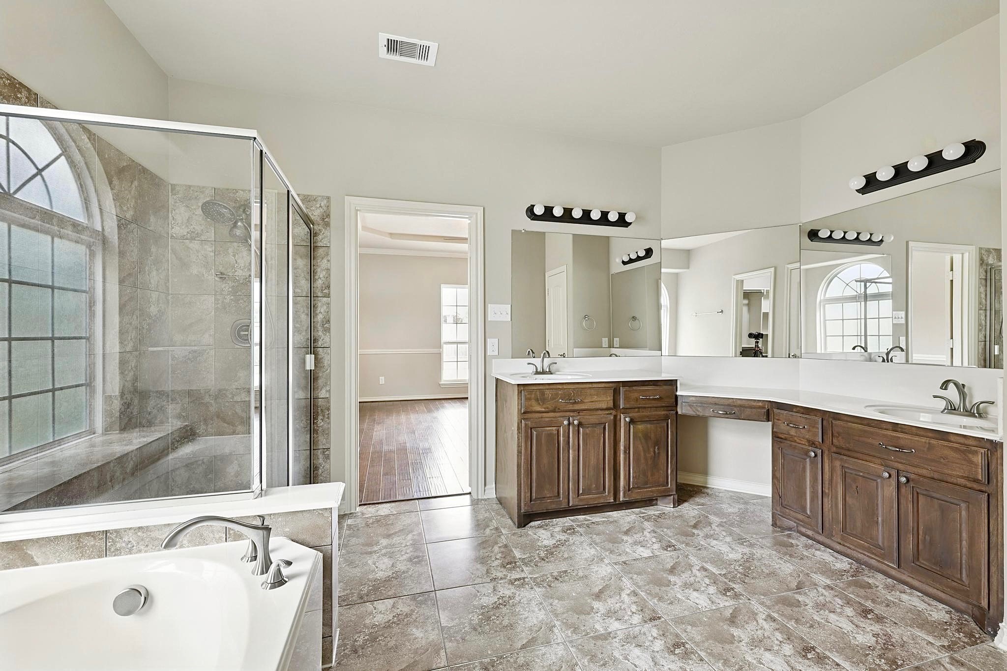 19818 Iceland Court Spring, TX 77379 - Photo 19 of 35 a large bathroom with a tub sink shower and mirror