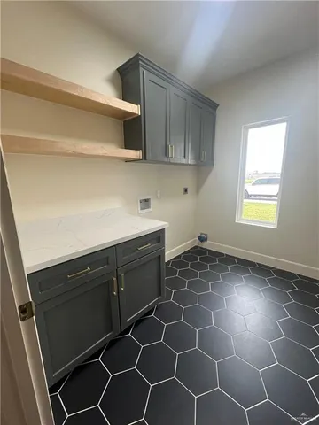 a kitchen with a sink a stove and cabinets