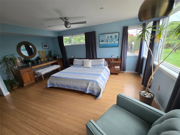 a spacious bedroom with a bed and large windows