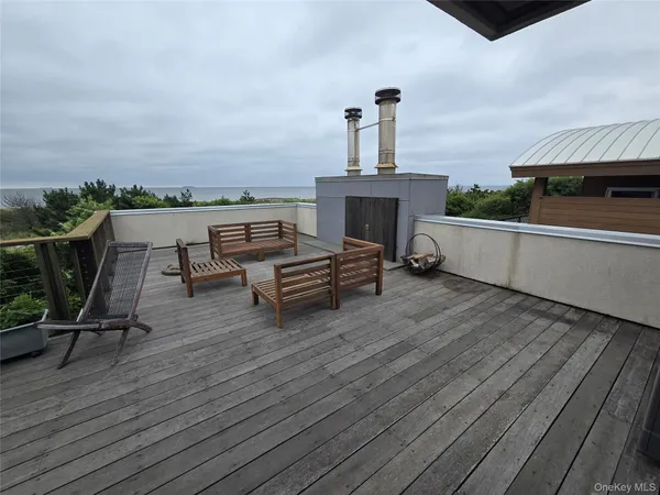 a living room with furniture a wooden floor and a sink