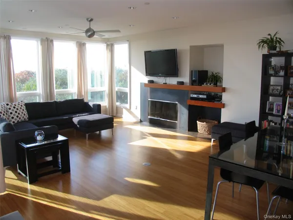 a living room with furniture and large windows