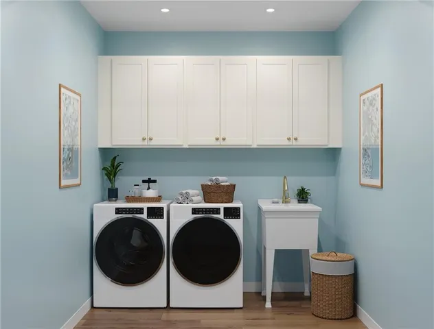 a utility room with sink dryer and washer